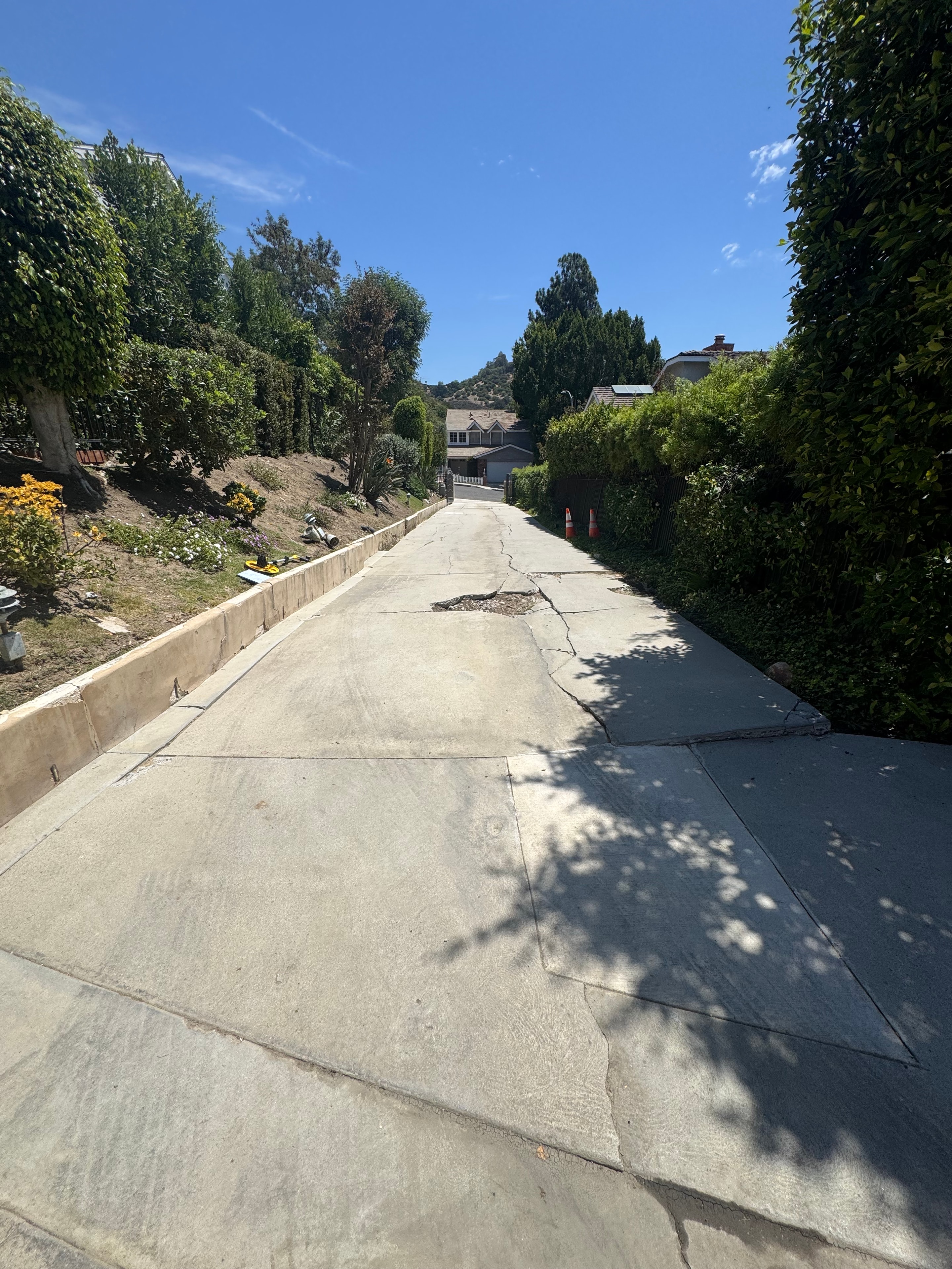 Cracked concrete driveway slab showing settlement, Los Angeles County — Concrete Etc., Inc.