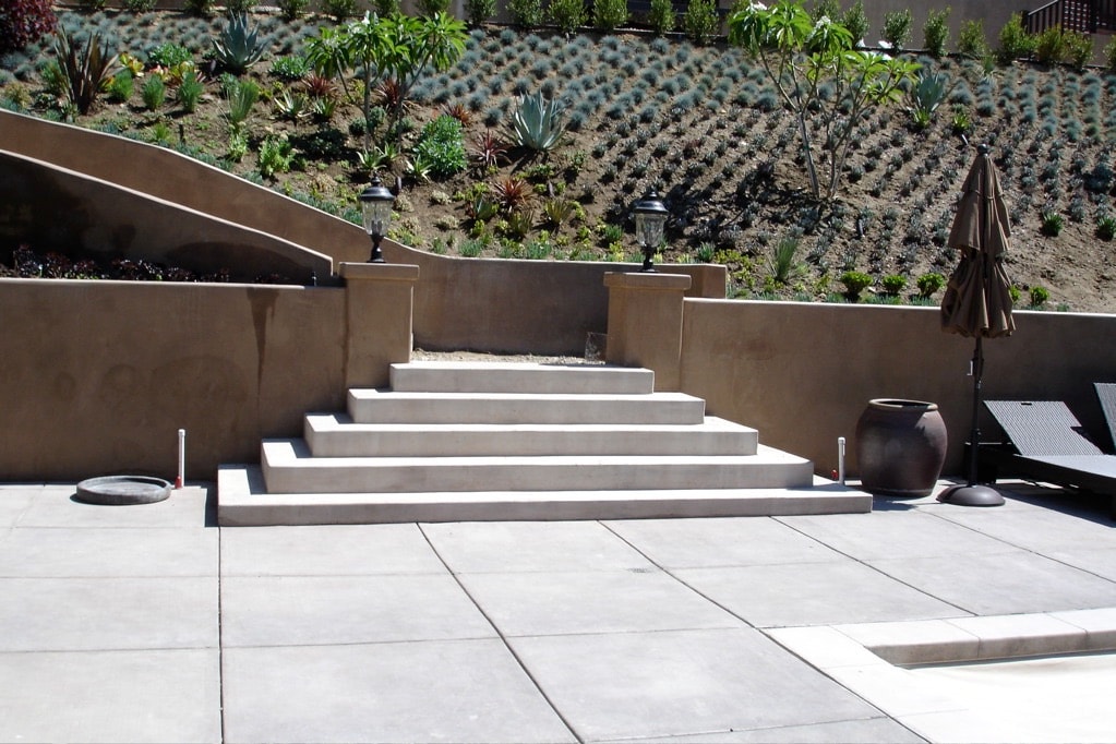 Concrete patio with steps on hillside property in San Fernando Valley, Los Angeles County — installed by Concrete Etc., Inc.