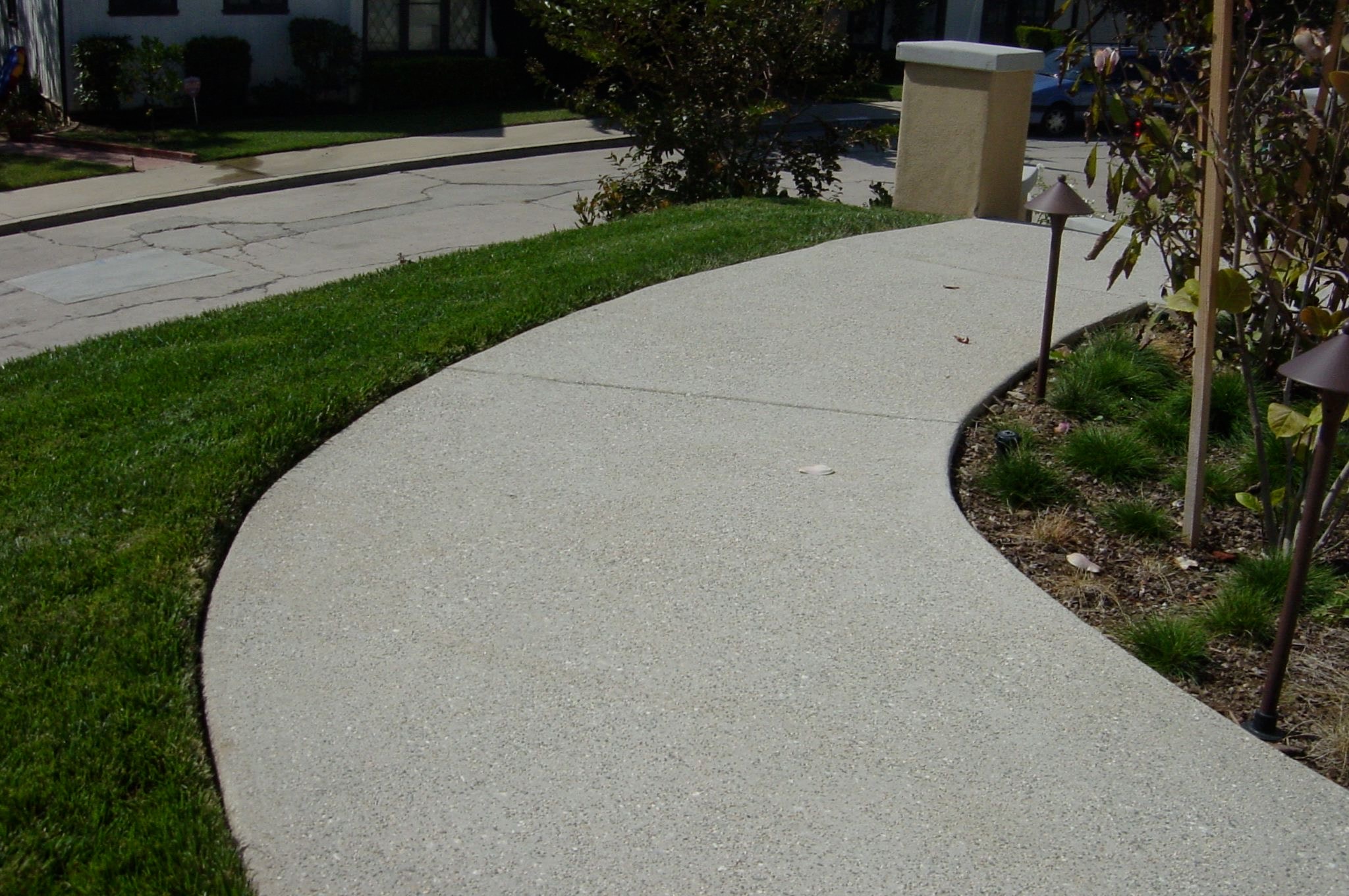 Curved sand-finish concrete walkway with lawn and landscape lighting — San Fernando Valley concrete contractor, Concrete Etc., Inc.