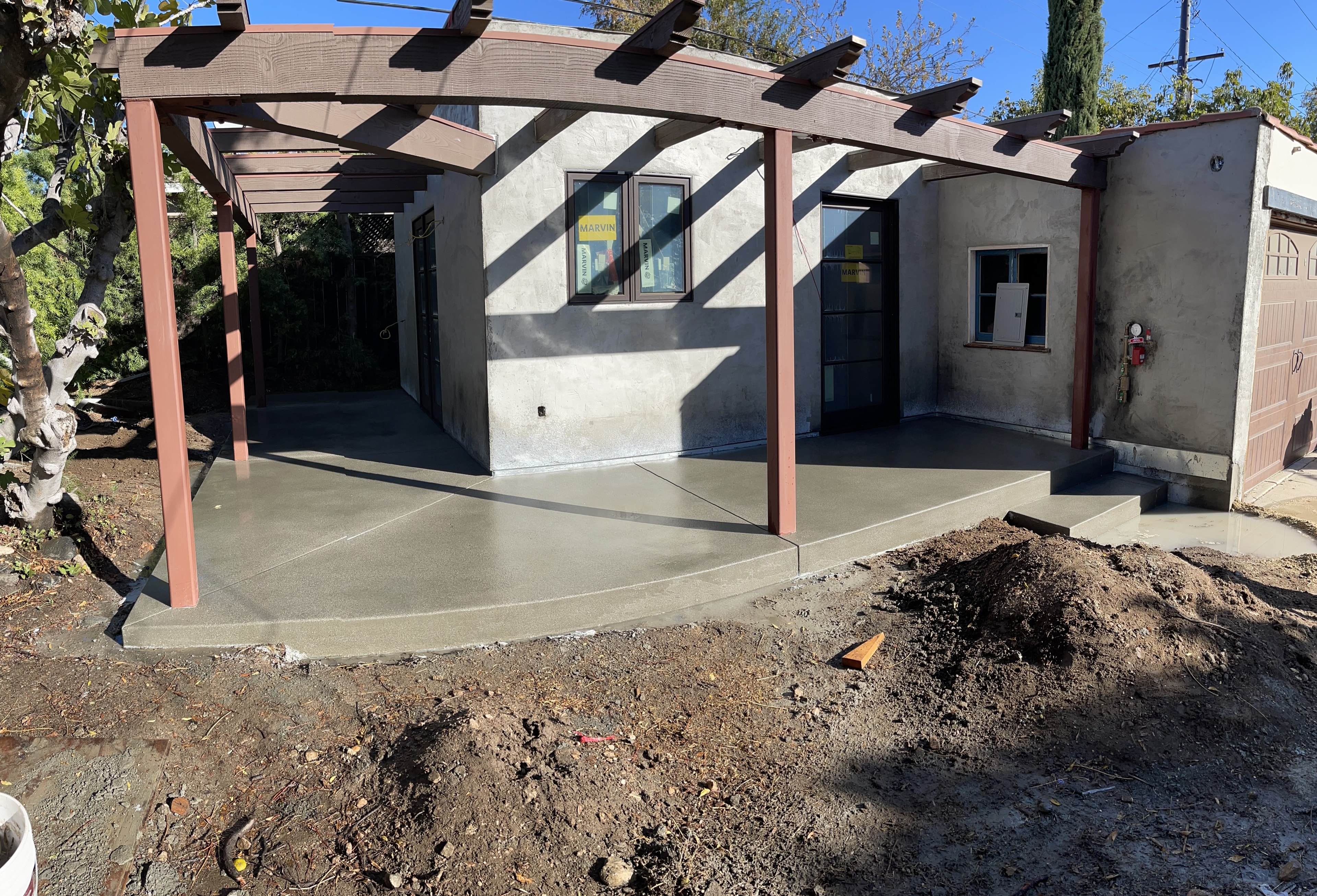 Completed ADU with stucco exterior and concrete patio slab, Los Angeles County