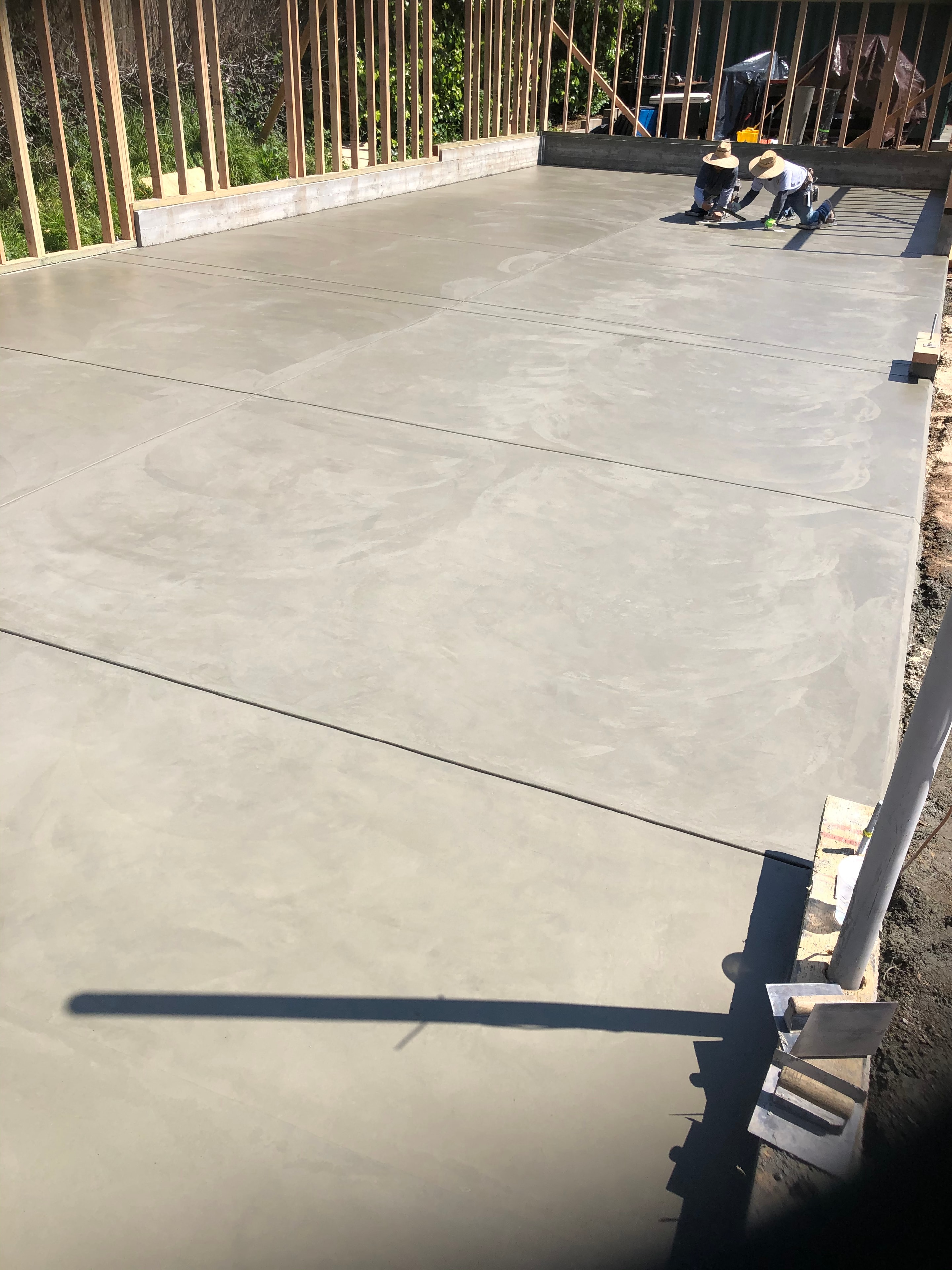 ADU concrete slab pour being finished by crew, Los Angeles County