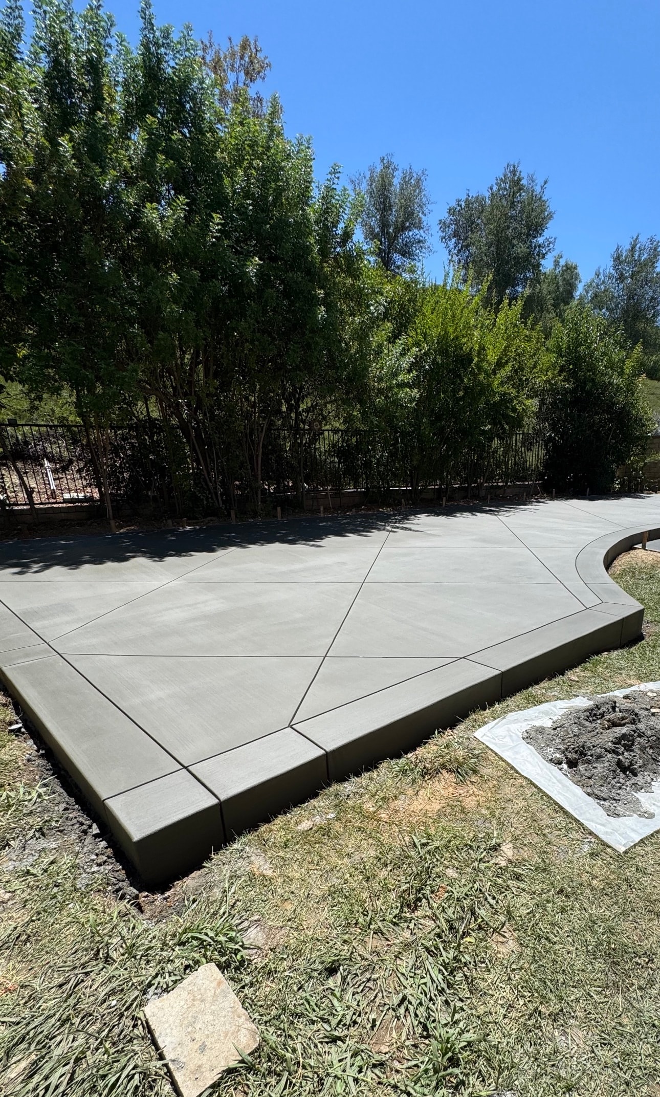 Completed broom finish concrete patio with decorative score line pattern and bull-nosed edge in Santa Clarita, CA by Concrete Etc., Inc.