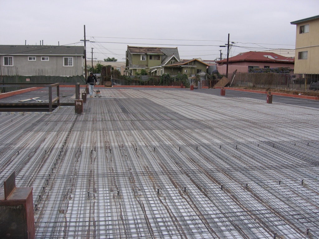 Large commercial concrete foundation with full rebar grid layout ready for pour on ground-up masonry building construction in Los Angeles by Concrete Etc., Inc.