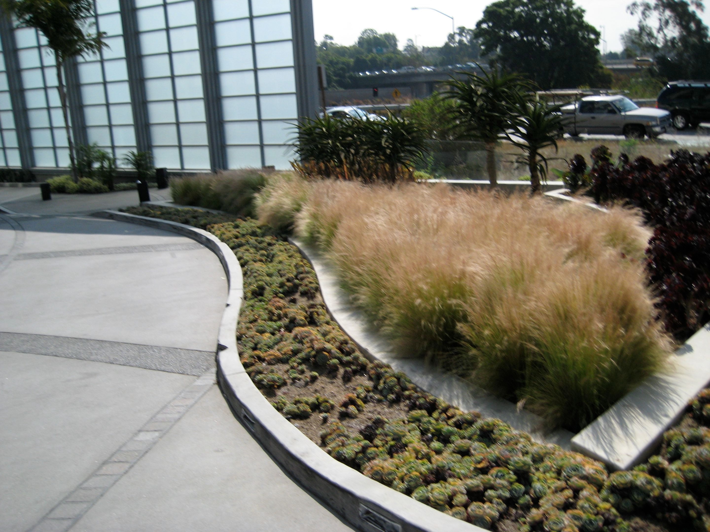 Sand finish concrete driveway with exposed aggregate bands installed at Hotel Angeleno in Los Angeles, CA by Concrete Etc., Inc.