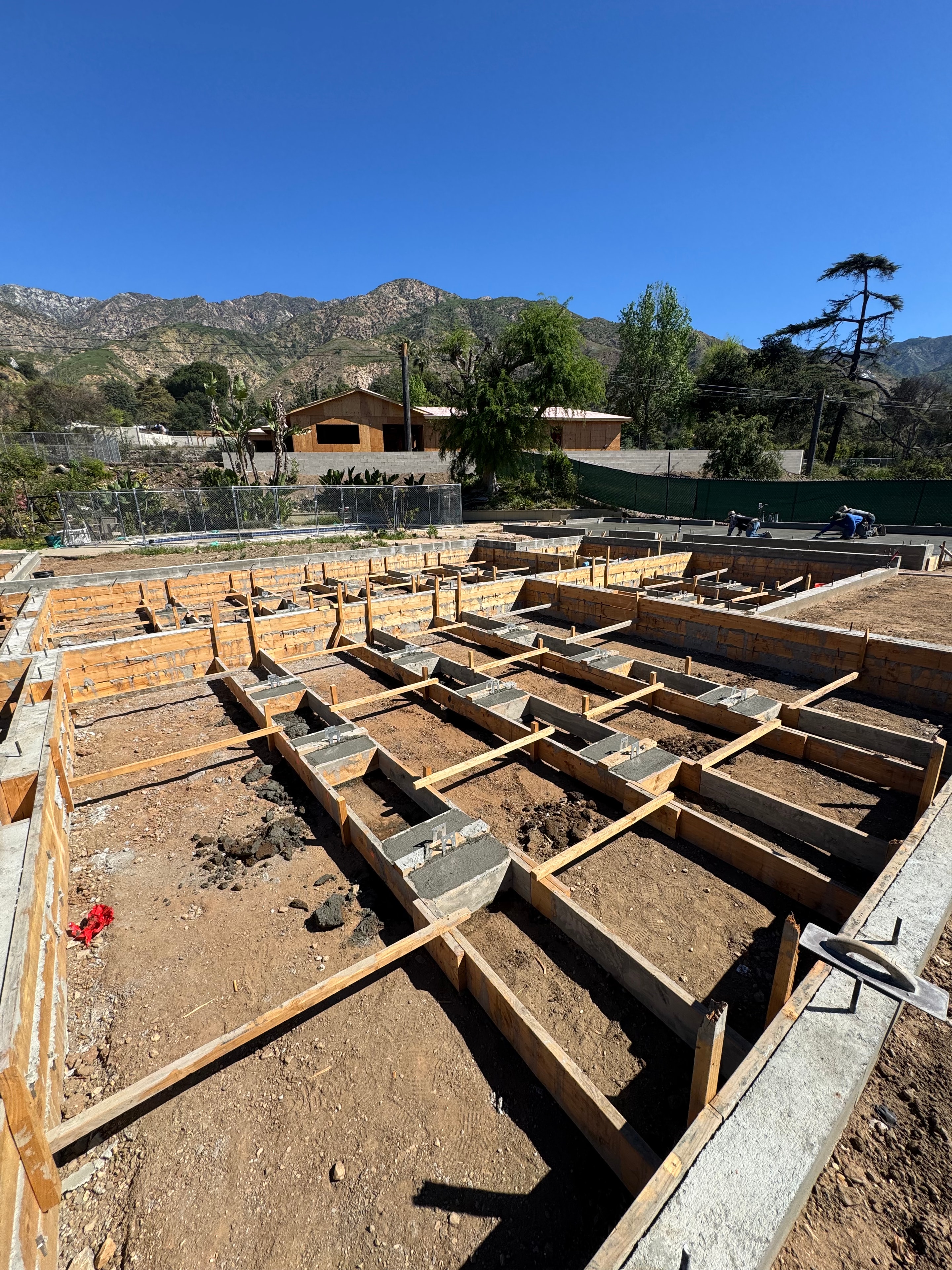 Concrete foundation stem walls with pad footings and wood formwork under construction in Altadena, CA by Concrete Etc., Inc.