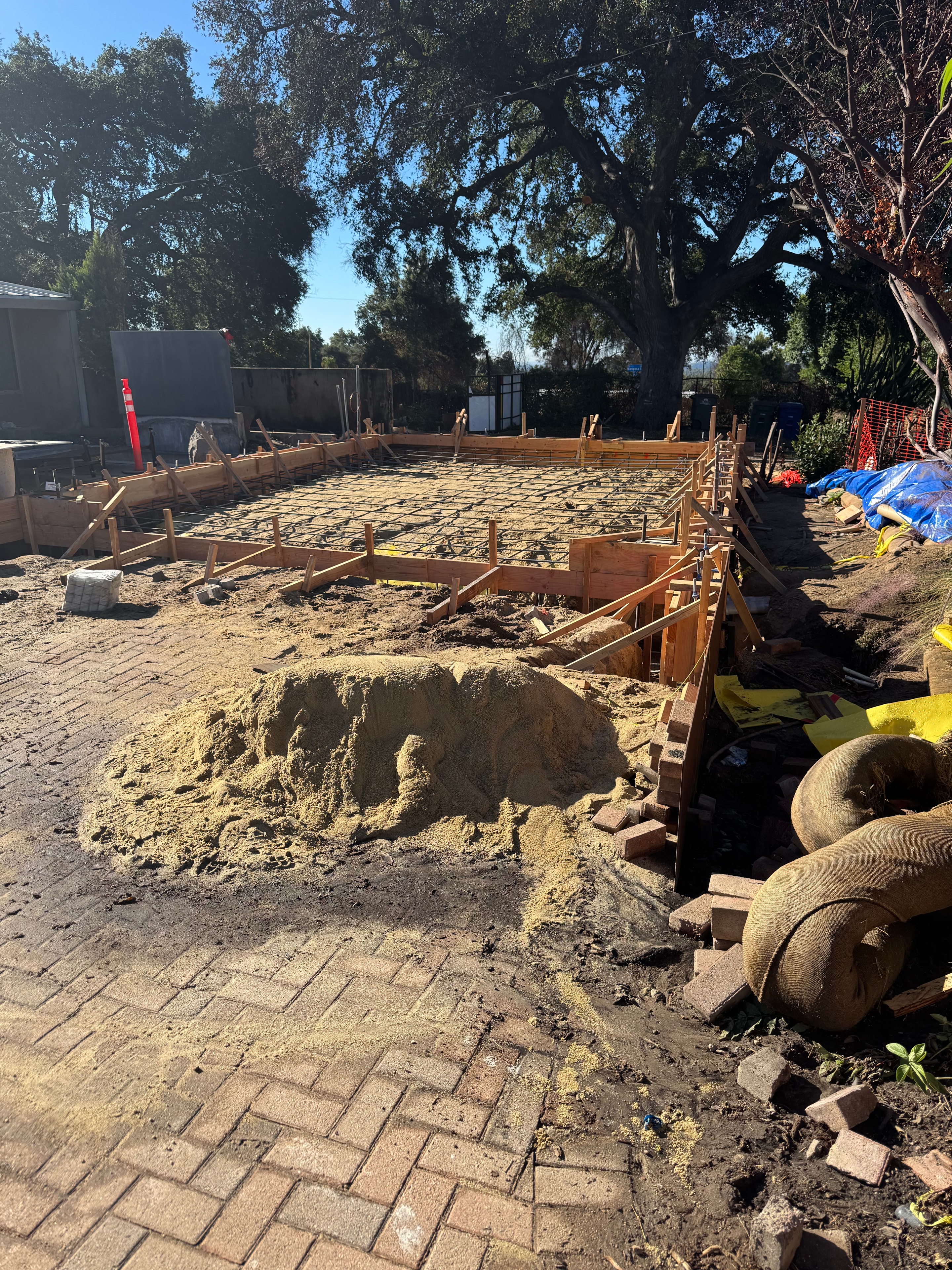 Structural concrete slab foundation with wood formwork, rebar mesh, footings and concrete curbs under construction in Altadena, CA by Concrete Etc., Inc.