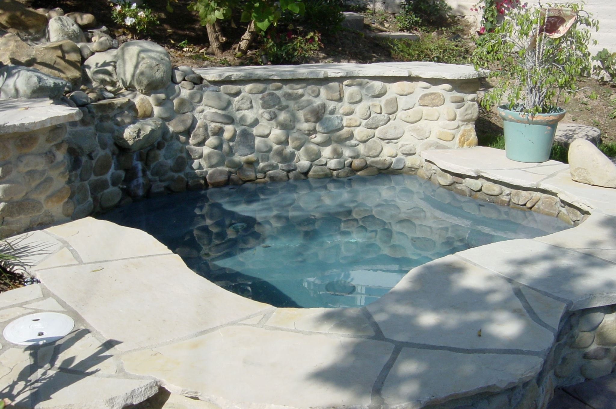 Concrete pool deck with flagstone natural stone coping installed by Concrete Etc., Inc. in Los Angeles County