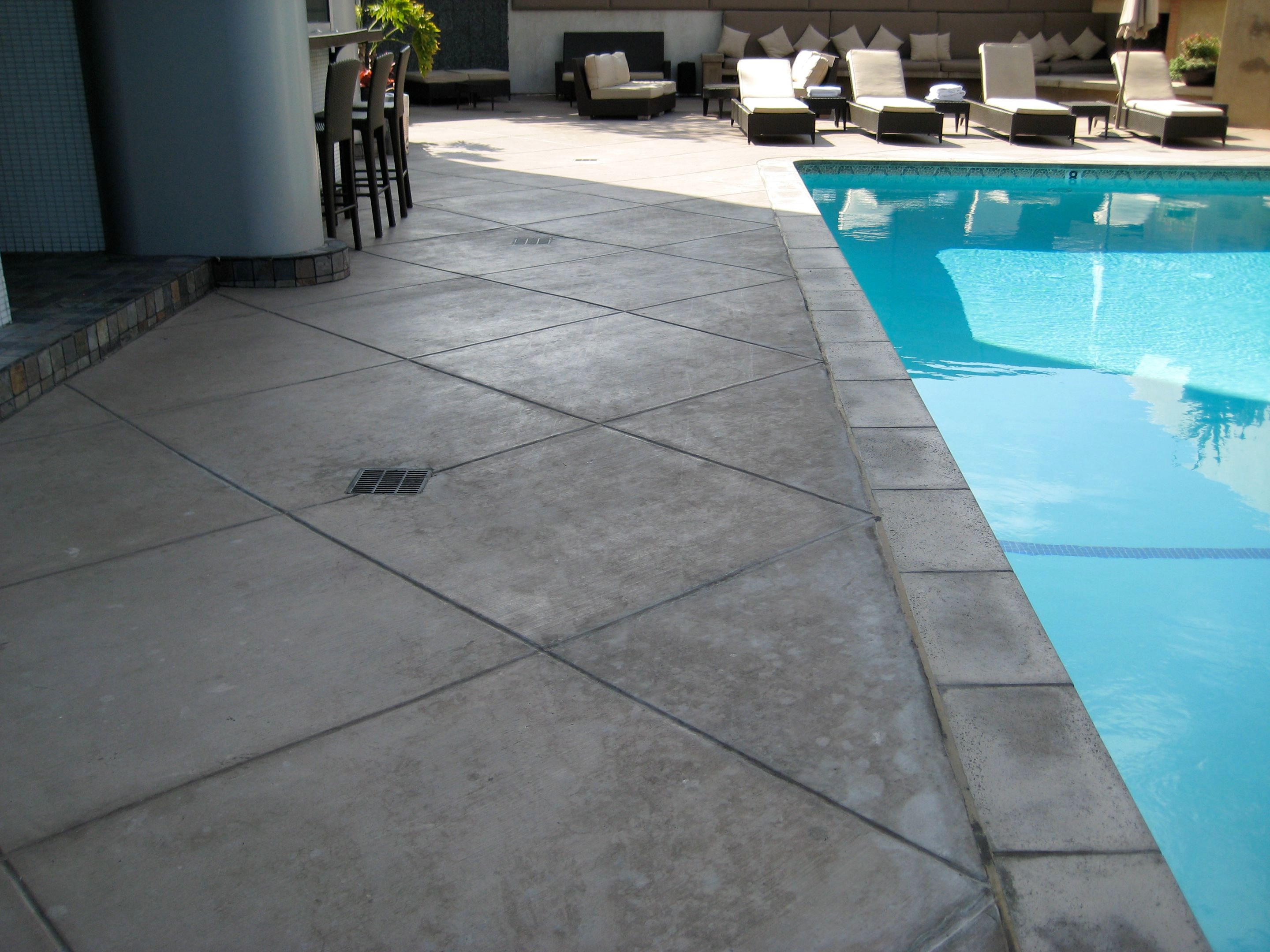 Broom finish concrete pool deck with diamond score pattern installed at Hotel Angeleno in Los Angeles, CA by Concrete Etc., Inc.