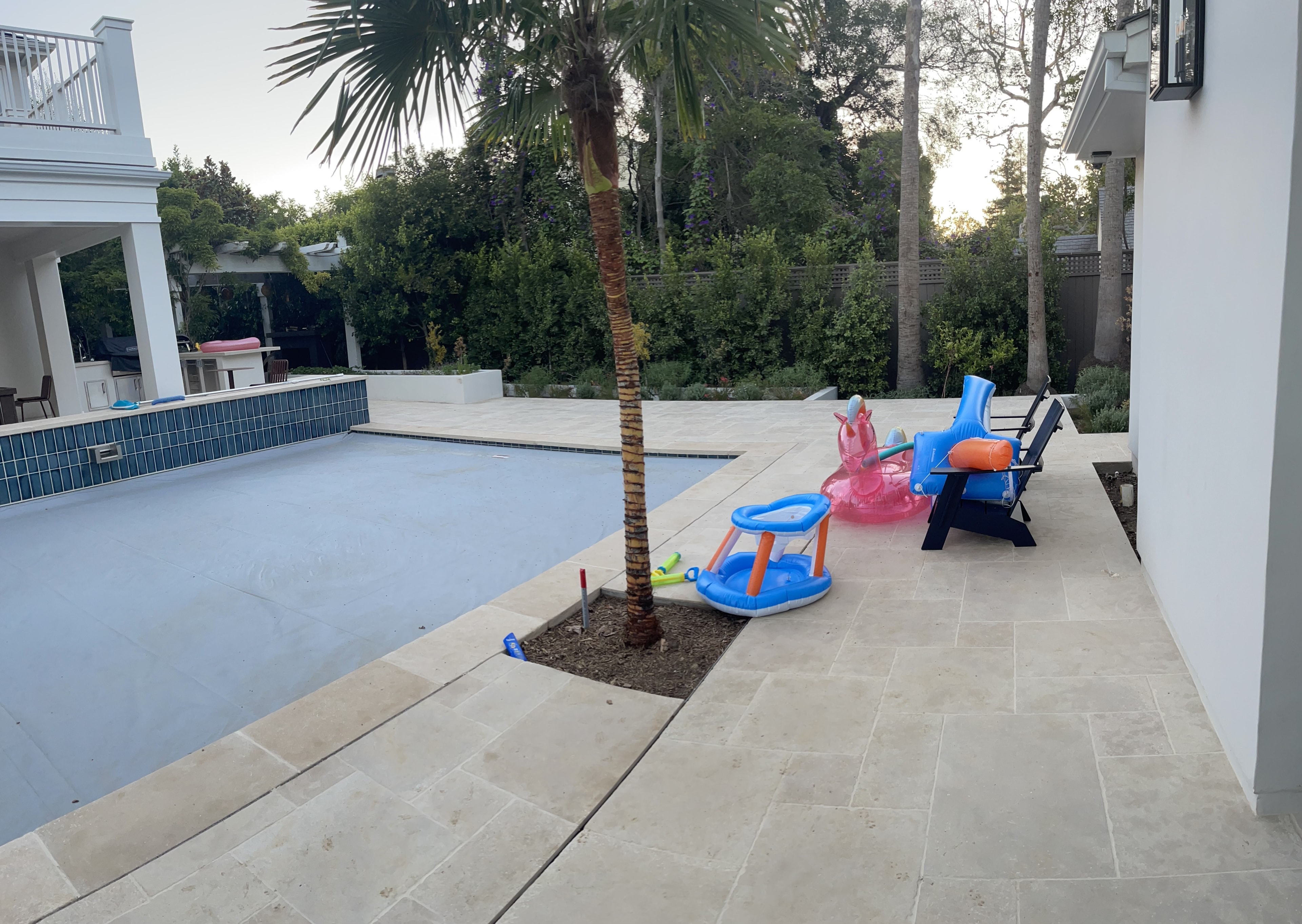 Concrete pool deck with tile coping and outdoor kitchen installed in Brentwood, CA by Concrete Etc., Inc.