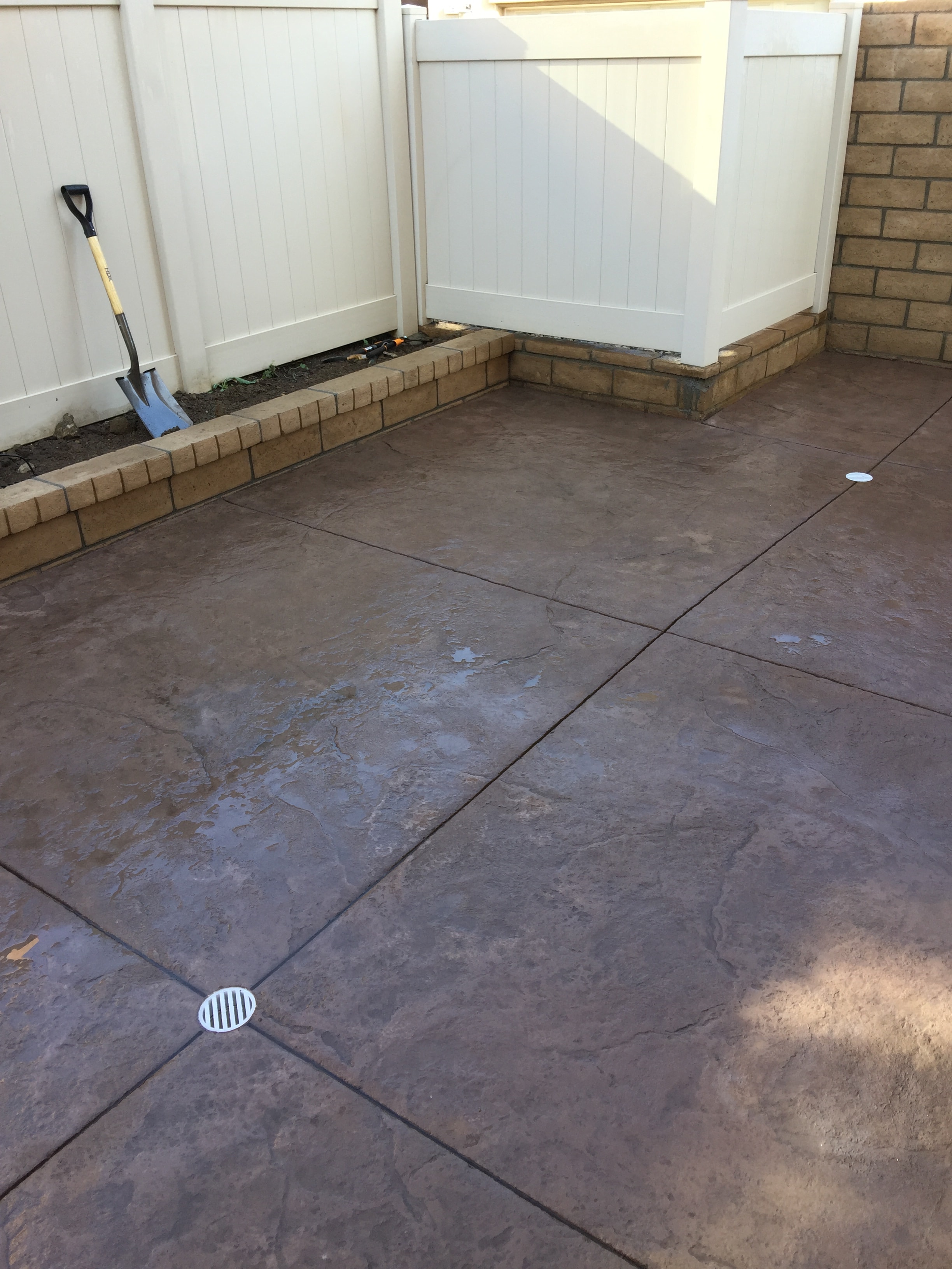 Freshly poured stamped concrete patio with slate texture and diagonal score lines at residential home in San Fernando Valley, Los Angeles by Concrete Etc., Inc.
