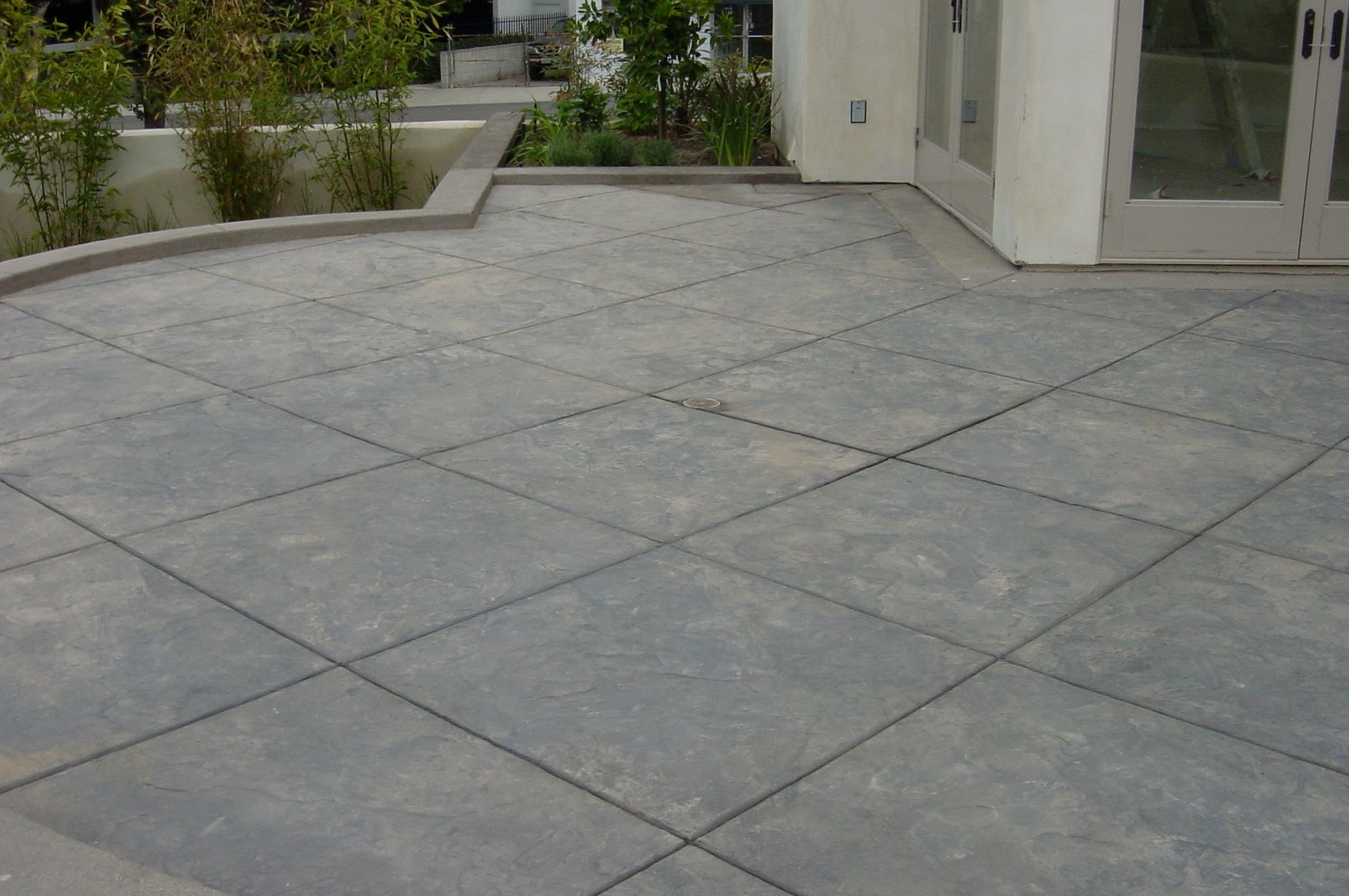 Stamped concrete patio with diamond pattern scoring by Concrete Etc.
